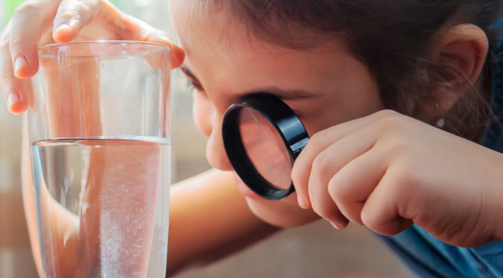 Visuel fillette loupe verre d'eau